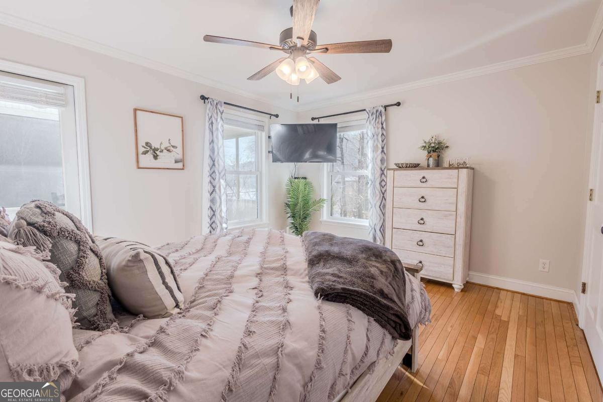 53 Addle Trail, Unit 2382 Ellijay, GA 30540 - Photo 20 of 42 a bedroom with a bed and ceiling fan