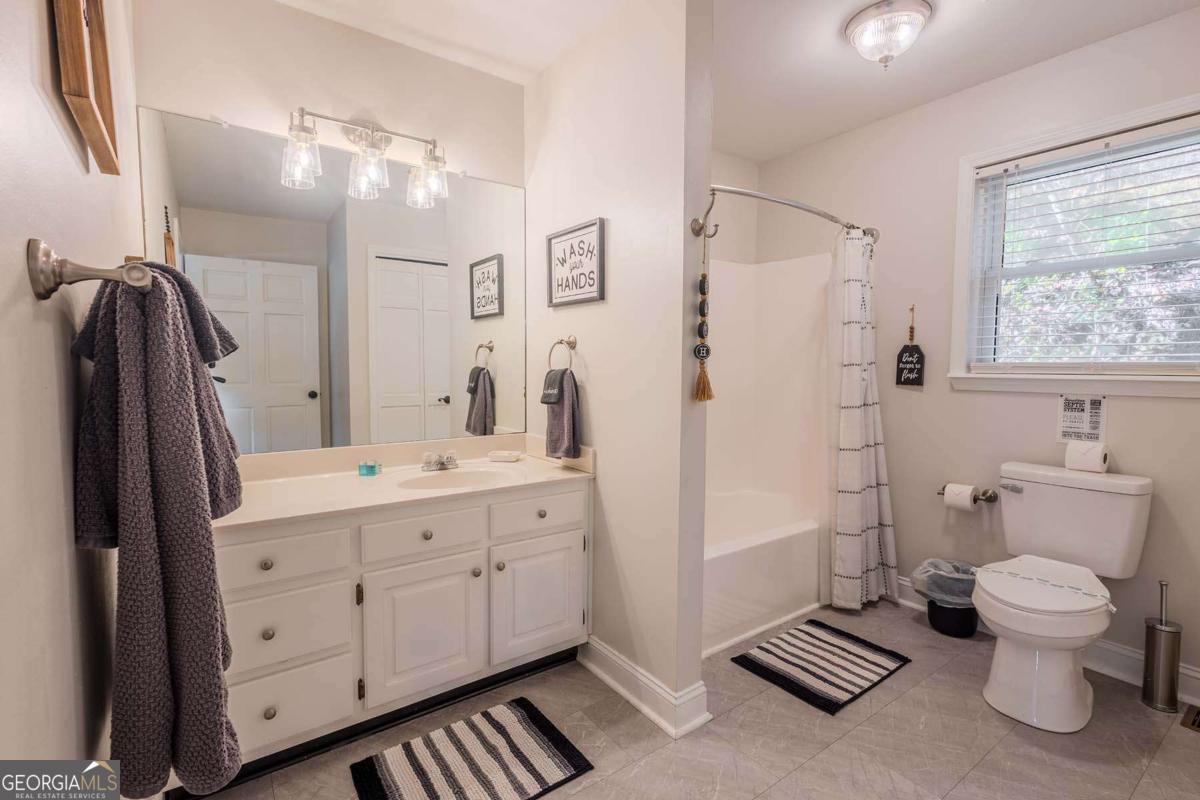 53 Addle Trail, Unit 2382 Ellijay, GA 30540 - Photo 21 of 42 a bathroom with a double vanity sink toilet and shower