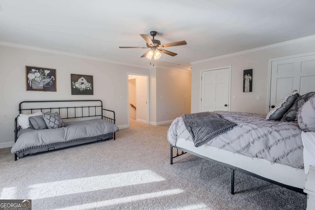 53 Addle Trail, Unit 2382 Ellijay, GA 30540 - Photo 24 of 42 a bedroom with a bed and a couch