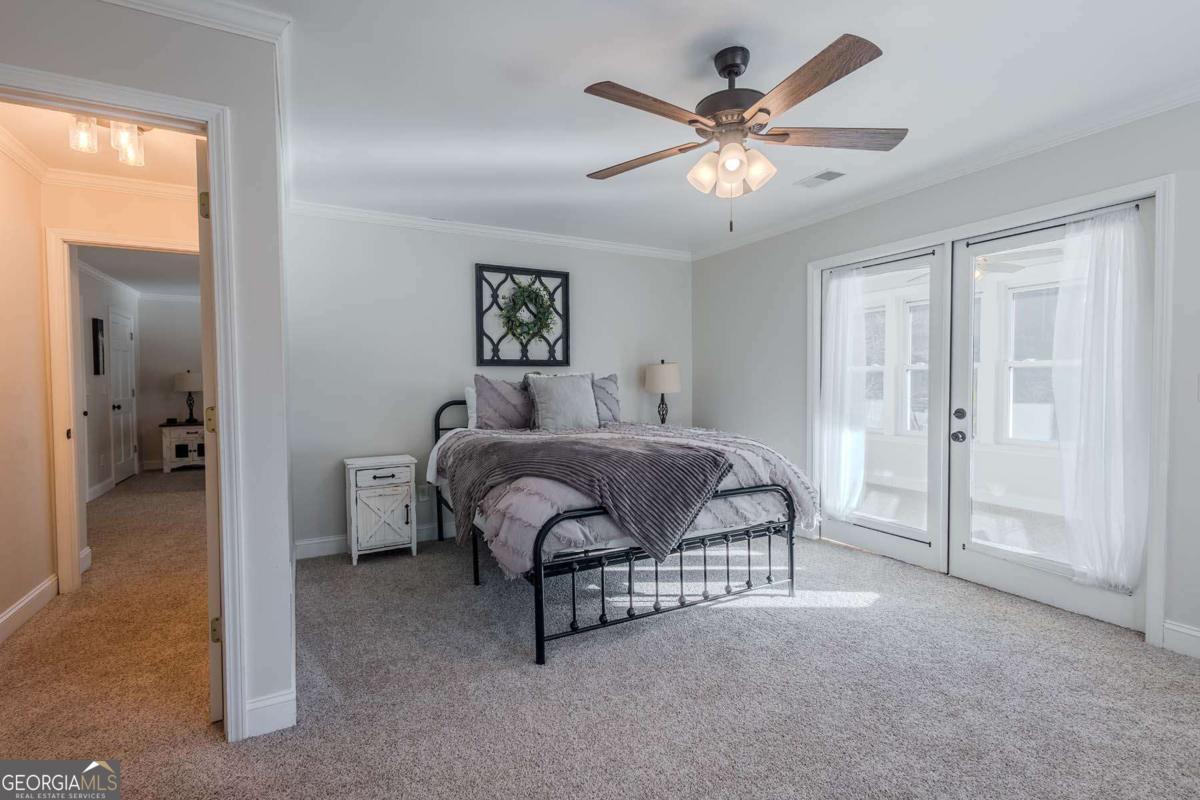 53 Addle Trail, Unit 2382 Ellijay, GA 30540 - Photo 28 of 42 a bedroom with a bed and a chandelier
