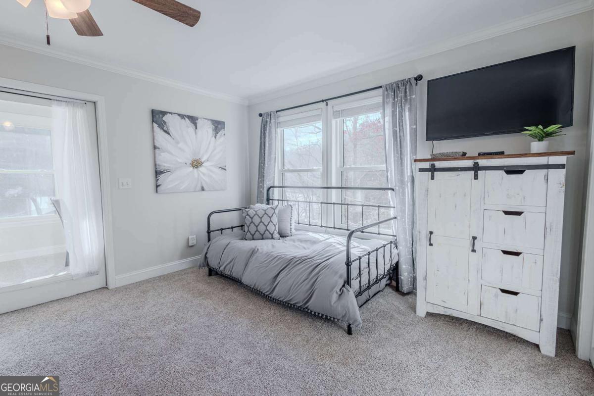 53 Addle Trail, Unit 2382 Ellijay, GA 30540 - Photo 30 of 42 a bedroom with a bed and a flat screen tv