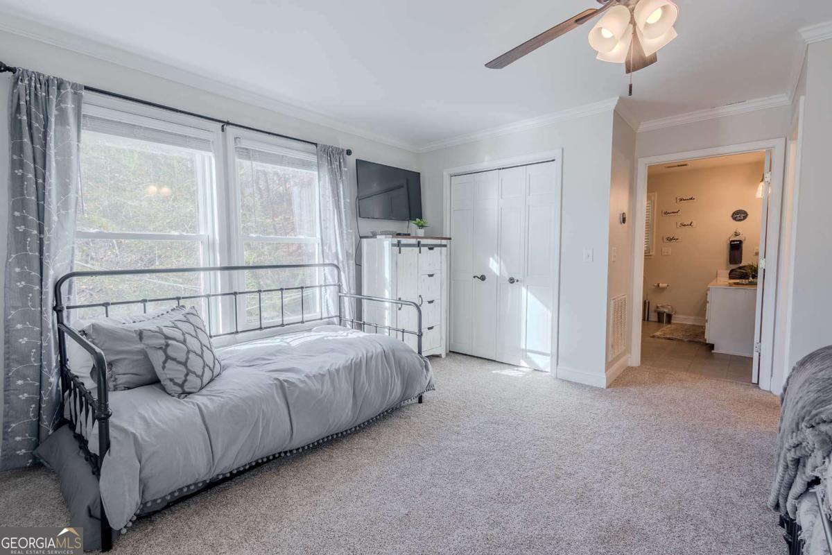 53 Addle Trail, Unit 2382 Ellijay, GA 30540 - Photo 31 of 42 a bed room with a bed and a chandelier