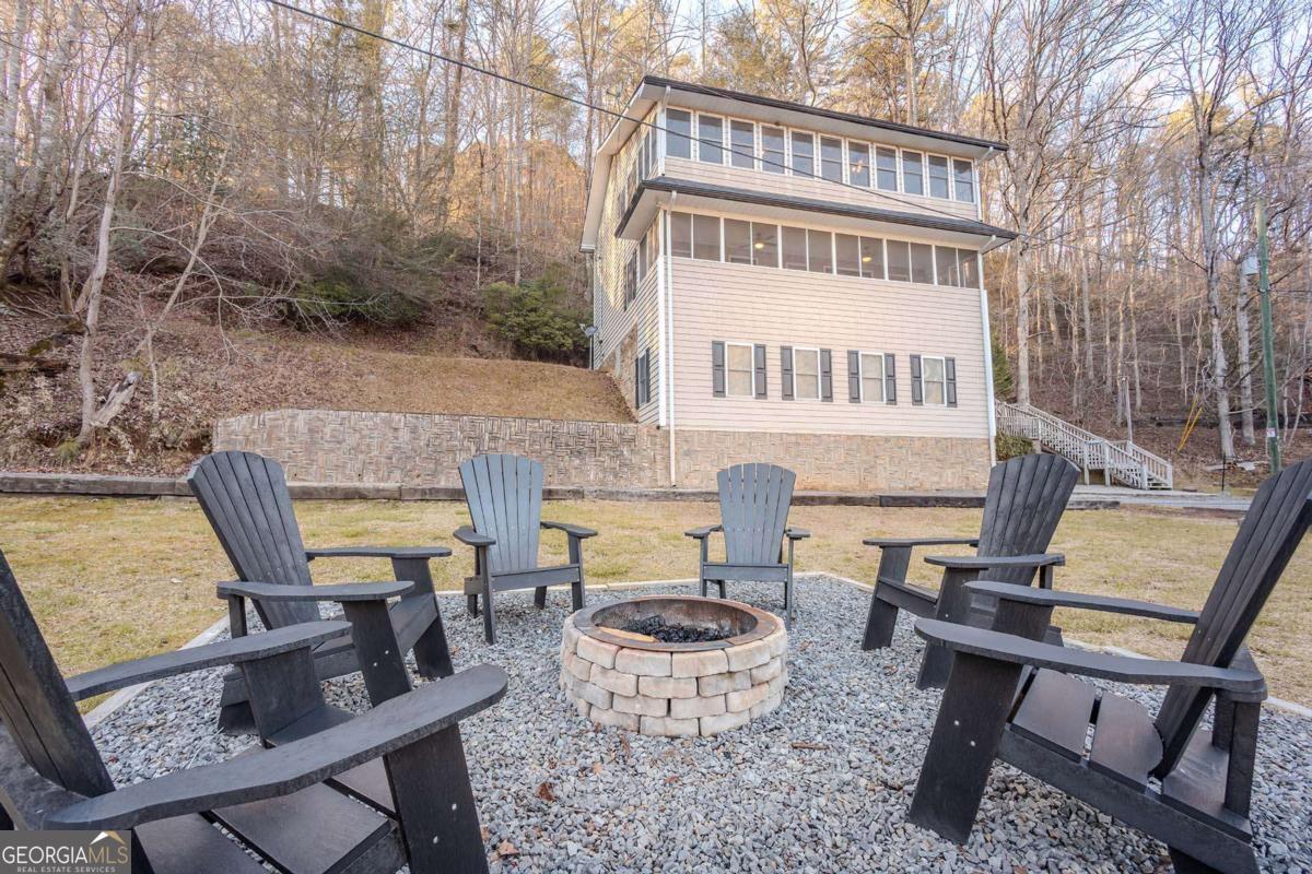 53 Addle Trail, Unit 2382 Ellijay, GA 30540 - Photo 6 of 42 a view of a chairs and table in the back yard of the house