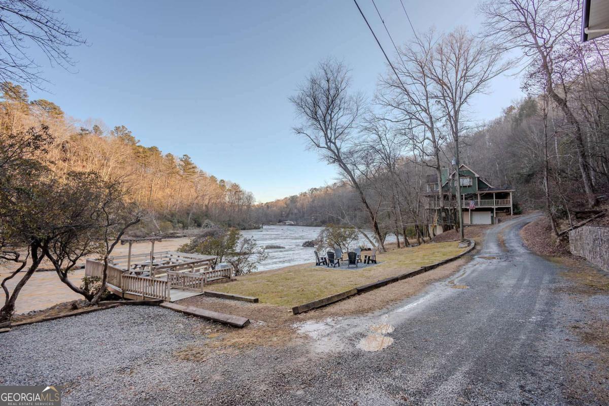 53 Addle Trail, Unit 2382 Ellijay, GA 30540 - Photo 7 of 42 a view of a fire pit with large trees
