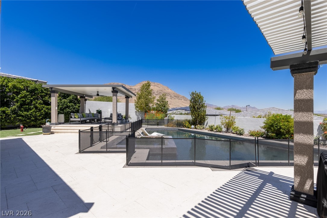10118 Copper Edge Road Las Vegas, NV 89148 - Photo 41 of 48 An inviting backyard oasis offers a sparkling pool, covered patio, and desert mountain views.