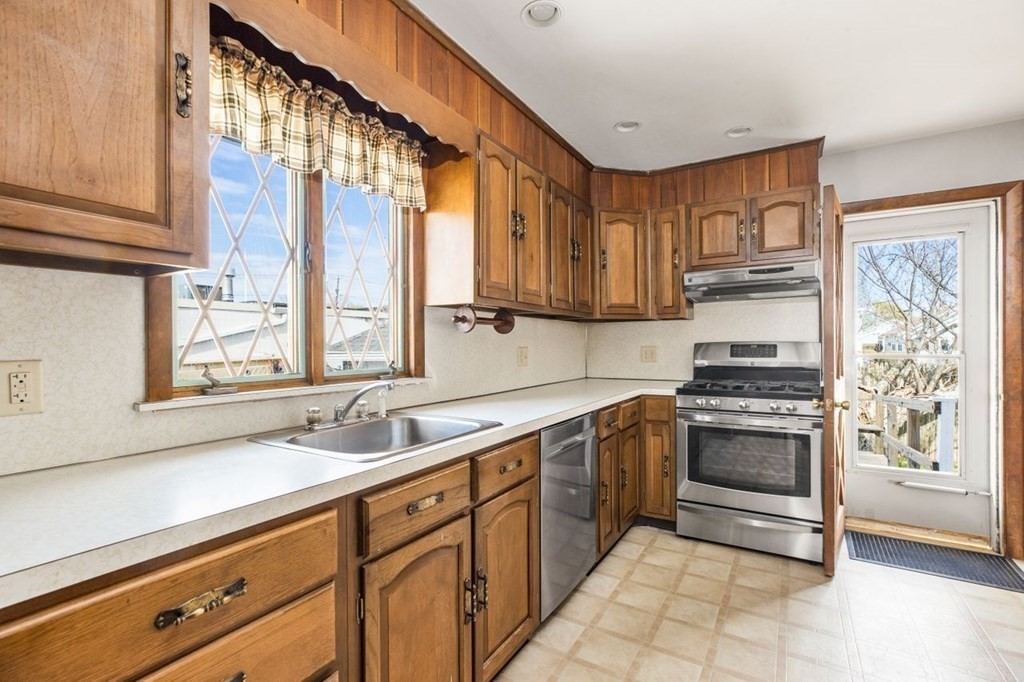 14 Johnson Road Weymouth, MA 02191 - Photo 12 of 33 a kitchen with stainless steel appliances granite countertop a sink stove and cabinets