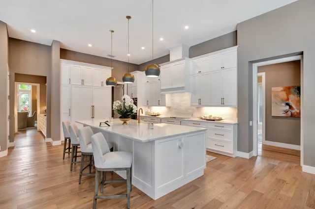 a dining room with furniture and a large window