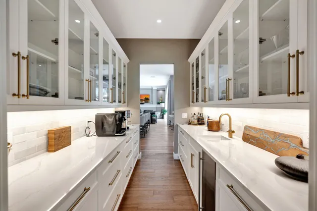 a living room with furniture a flat screen tv and a floor to ceiling window