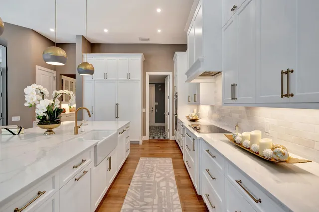 a living room with furniture potted plant and a large window
