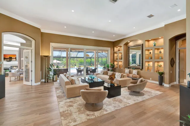 a living room with furniture and a view of kitchen