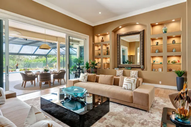 a large white kitchen with a large window and cabinets