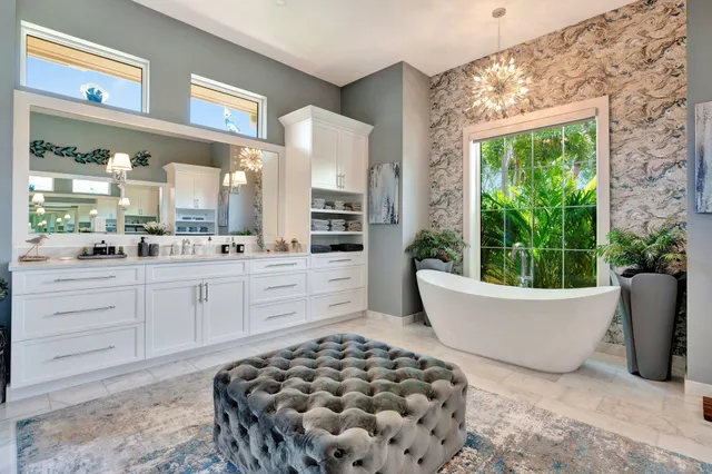 a front view of a house with a yard and potted plants