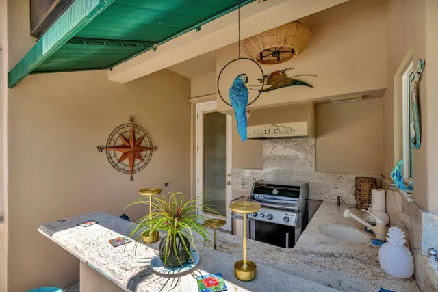 a front view of a house with a yard and potted plants