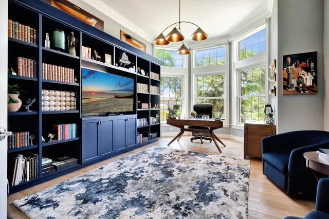 a front view of a house with a yard and potted plants
