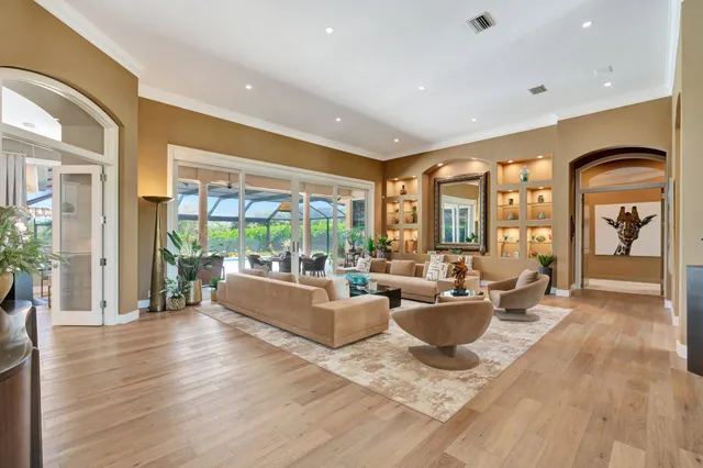 a view of a dining room with furniture wooden floor and a chandelier