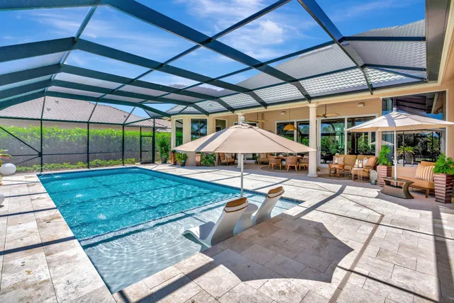 a living room with furniture and large windows