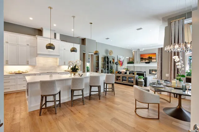 a living room with fireplace furniture and a large window