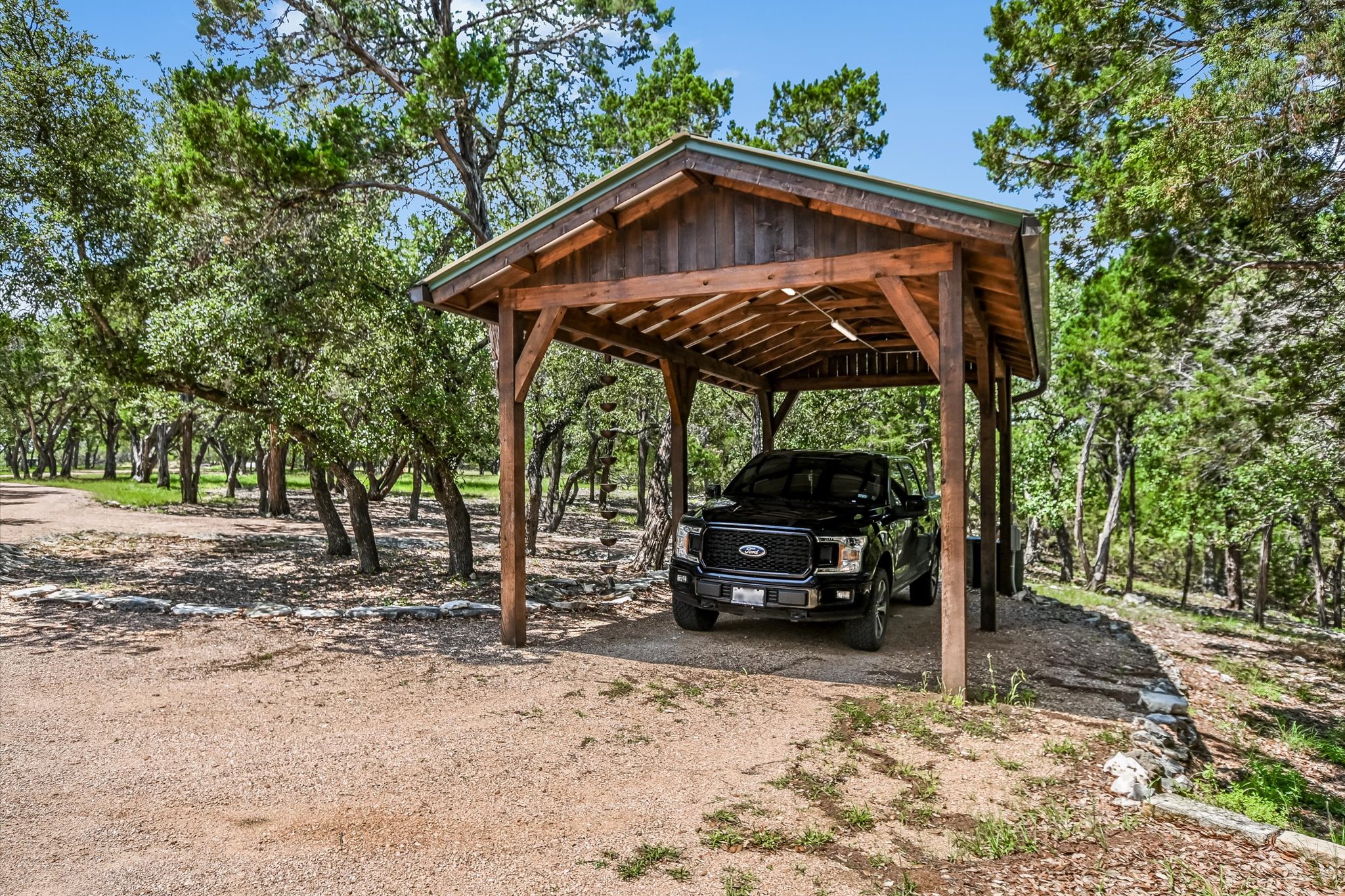 817 Woodcreek Ranch Road Wimberley, TX 78676 - Photo 37 of 40 Carport for RV, boat, additional vehicle parking w/ power & remote operated lights