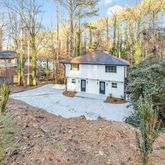 a view of a house with a yard covered in snow