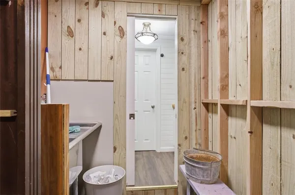 a utility room with lots of wooden furniture