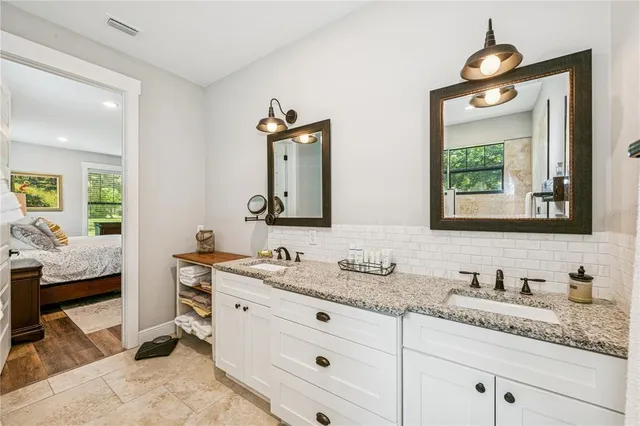 a en suite bathroom with double vanity sinks and a mirror