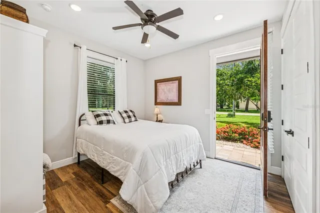 a bedroom with a bed mirror and window