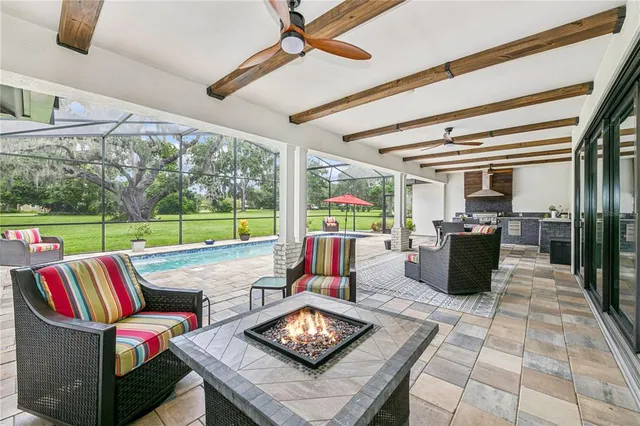a living room with furniture and a floor to ceiling window