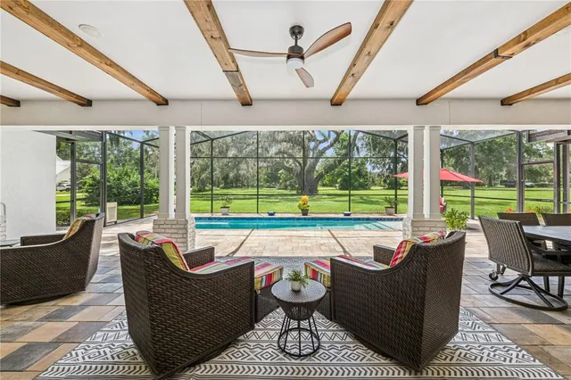 a living room with furniture and a floor to ceiling window
