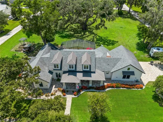 an aerial view of a house with a big yard