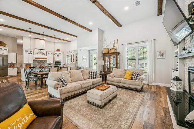 a living room with furniture wooden floor and a fireplace