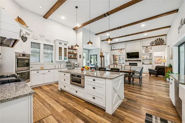 a kitchen with stainless steel appliances granite countertop a stove and cabinets