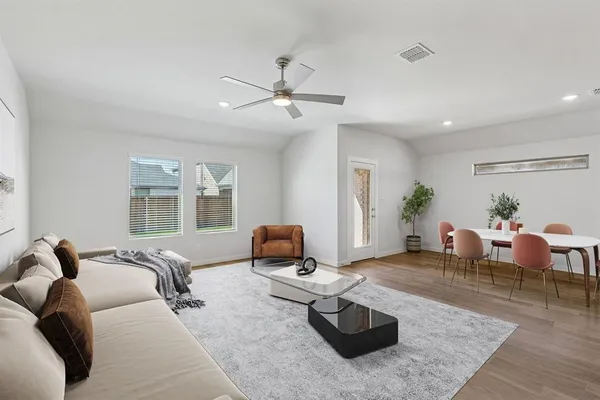 a kitchen with a sink and wooden floor