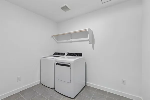 a view of a kitchen with a sink and a refrigerator