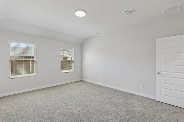 a bedroom with bed and window
