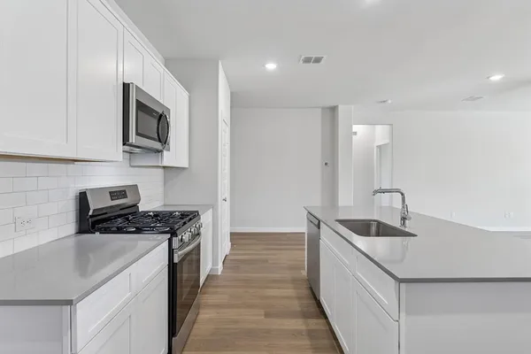 a kitchen that has a sink and a stove