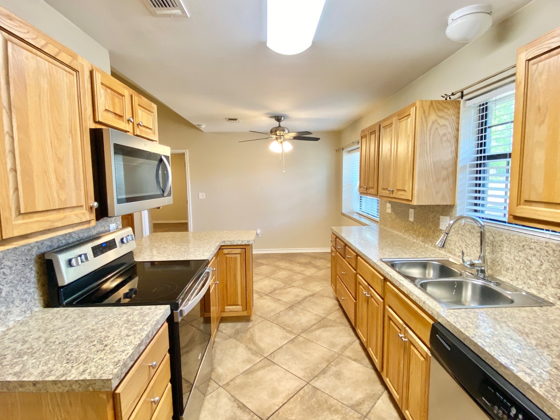 2745 Bethlehem Road Lufkin, TX 75904 - Photo 5 of 14 a kitchen with a stove a sink and a microwave