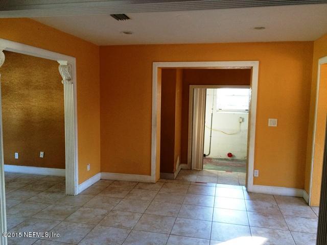 6520 Diane Road Jacksonville, FL 32277 - Photo 3 of 16 a view of a hallway with wooden shelves