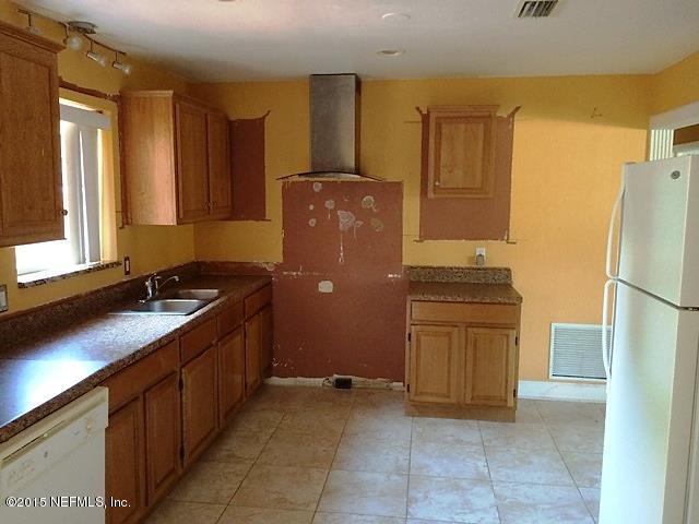 6520 Diane Road Jacksonville, FL 32277 - Photo 4 of 16 a kitchen with a refrigerator and a sink