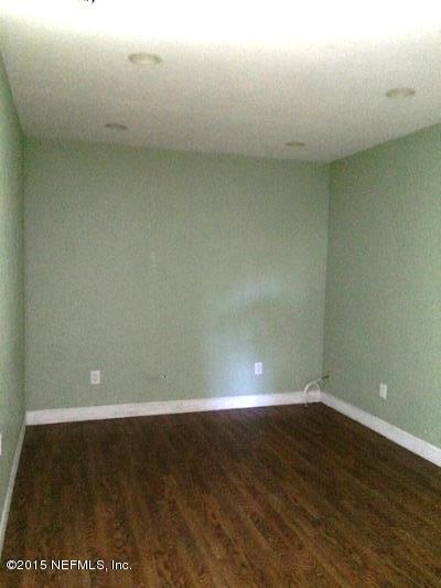 6520 Diane Road Jacksonville, FL 32277 - Photo 6 of 16 a view of an empty room with wooden floor