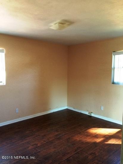 6520 Diane Road Jacksonville, FL 32277 - Photo 7 of 16 a view of an empty room and wooden floor