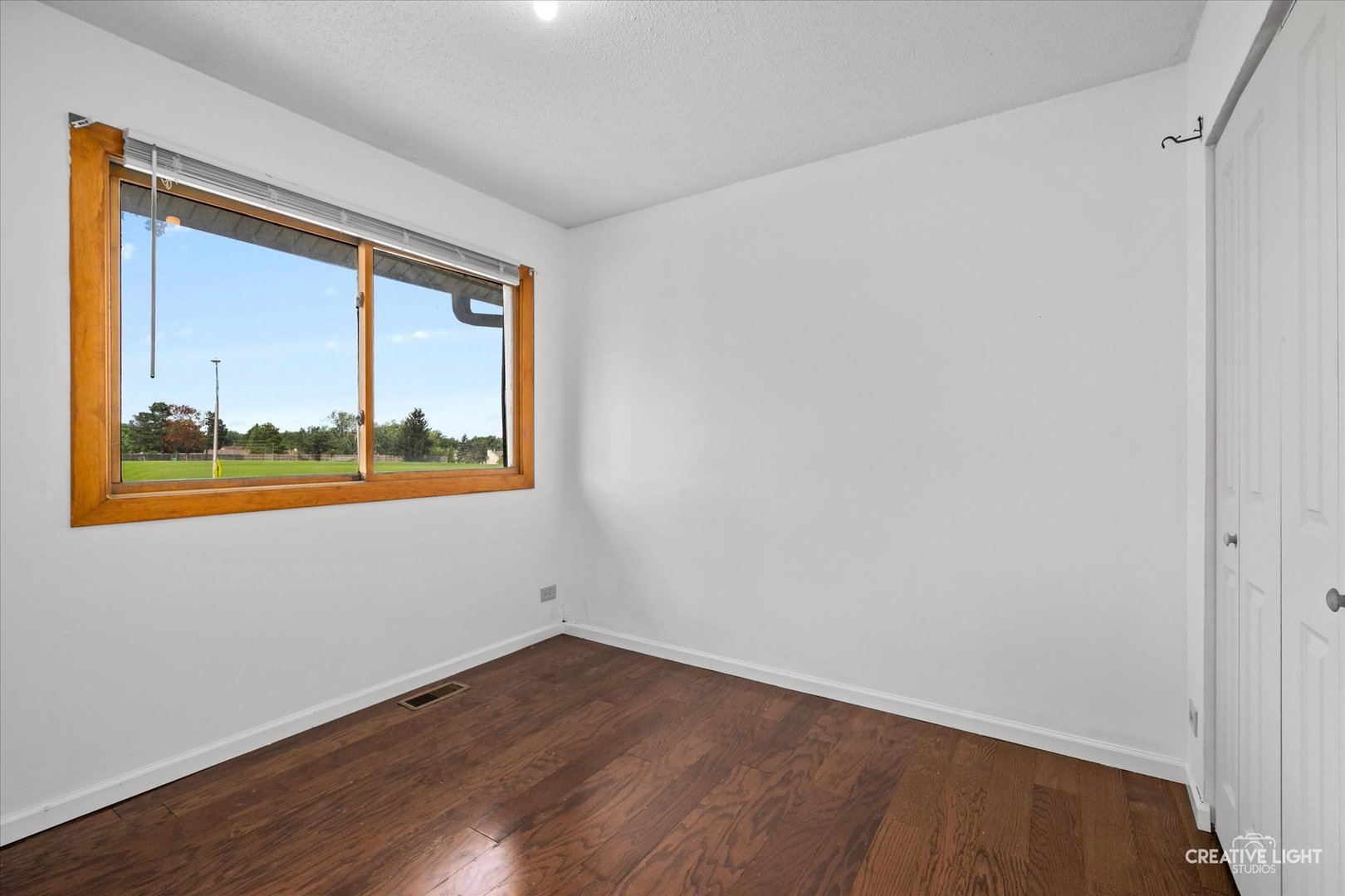 937 Sandpiper Court Bartlett, IL 60103 - Photo 11 of 17 a view of an empty room with wooden floor and a window