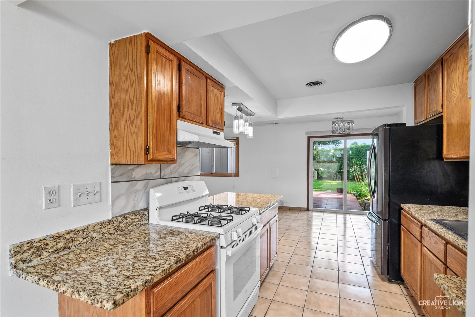 937 Sandpiper Court Bartlett, IL 60103 - Photo 4 of 17 a kitchen with stainless steel appliances granite countertop a stove a sink and a refrigerator