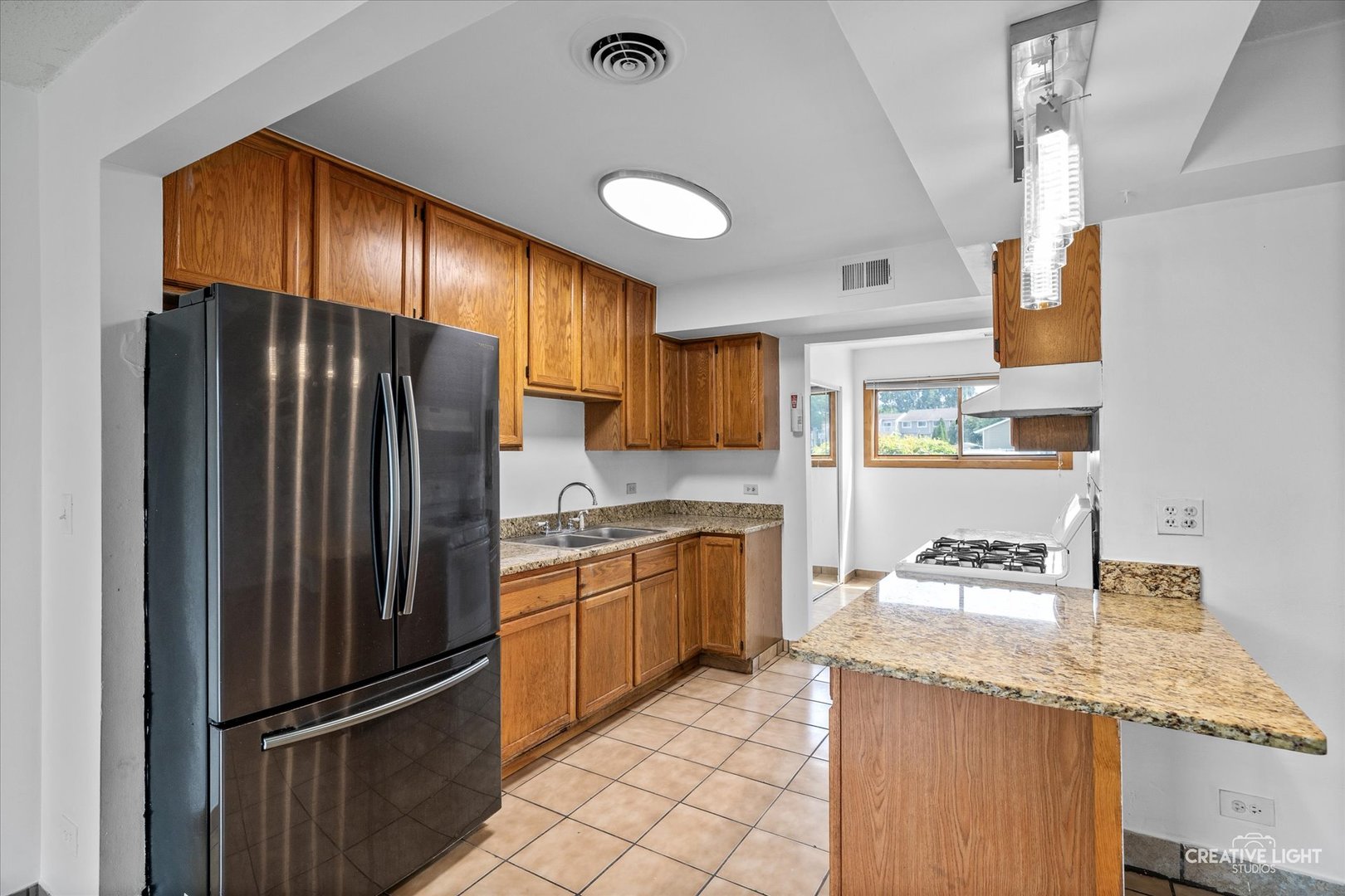 937 Sandpiper Court Bartlett, IL 60103 - Photo 5 of 17 a kitchen with granite countertop stainless steel appliances a refrigerator and counter space