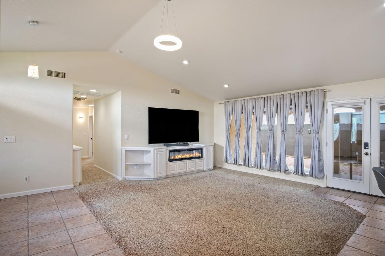 845 Pointe Lourose Avenue Gustine, CA 95322 - Photo 15 of 34 a living room with furniture and a flat screen tv