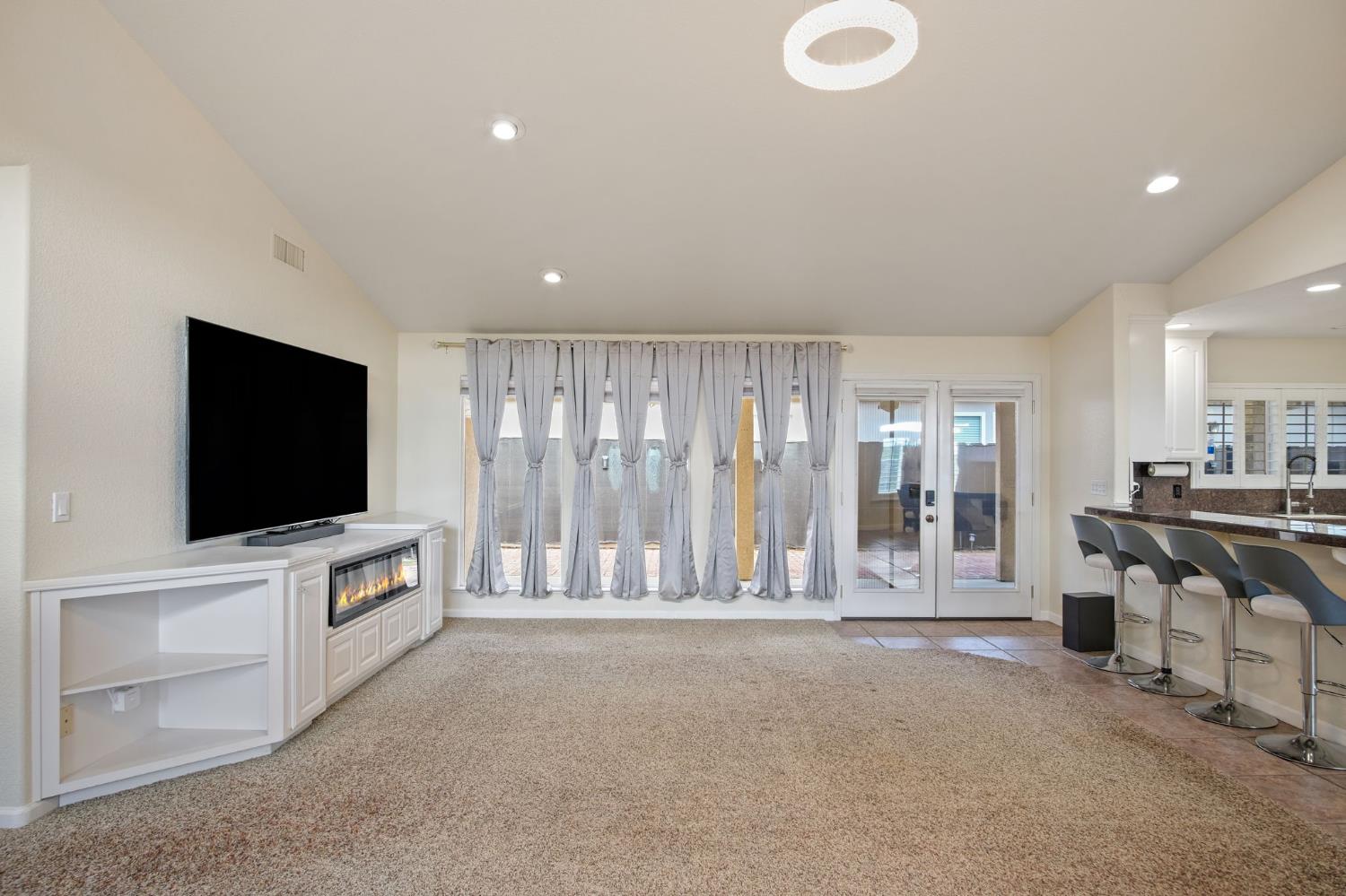 845 Pointe Lourose Avenue Gustine, CA 95322 - Photo 16 of 34 a living room with furniture and a flat screen tv