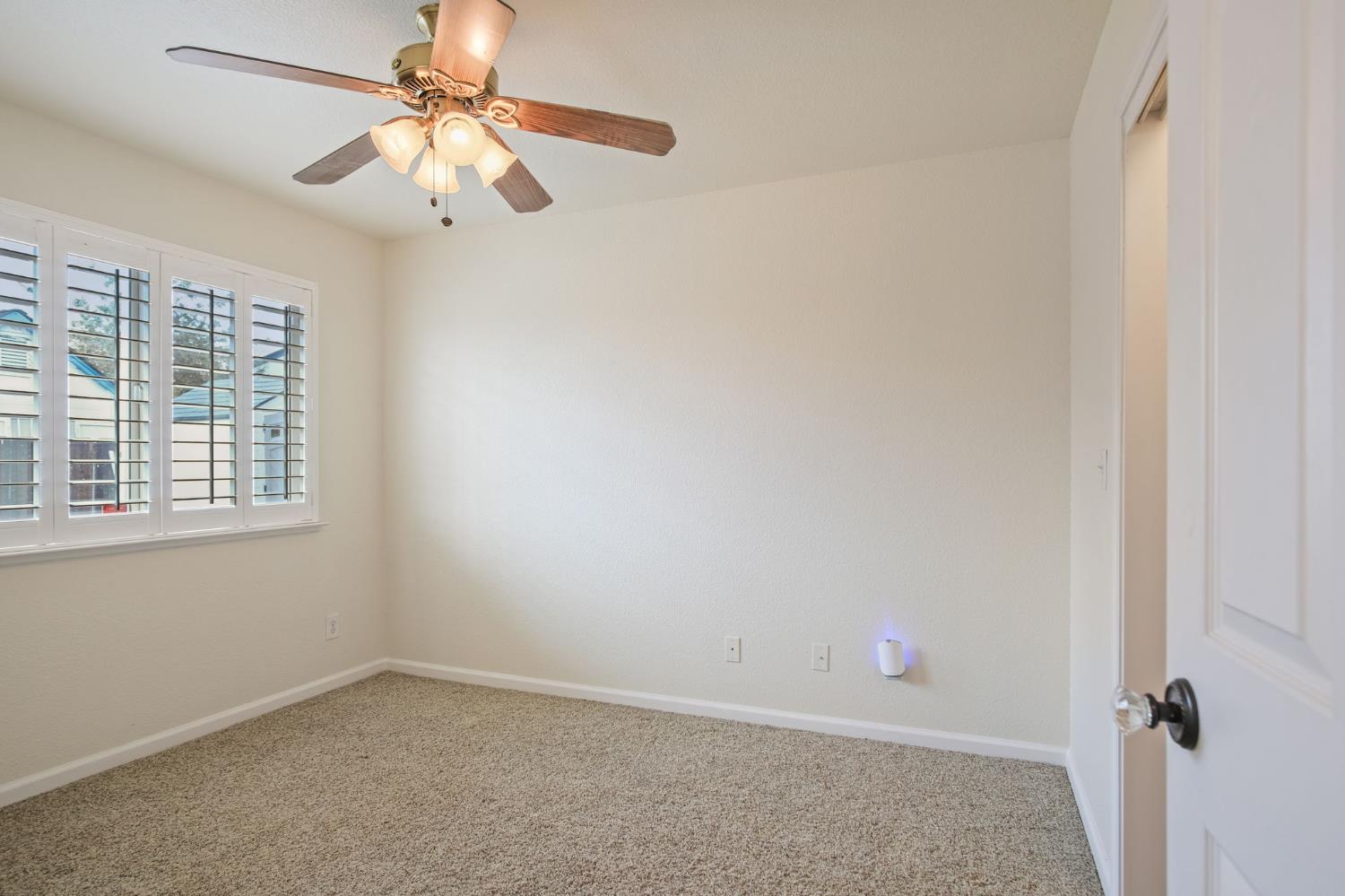 845 Pointe Lourose Avenue Gustine, CA 95322 - Photo 22 of 34 an empty room with a window and a fan