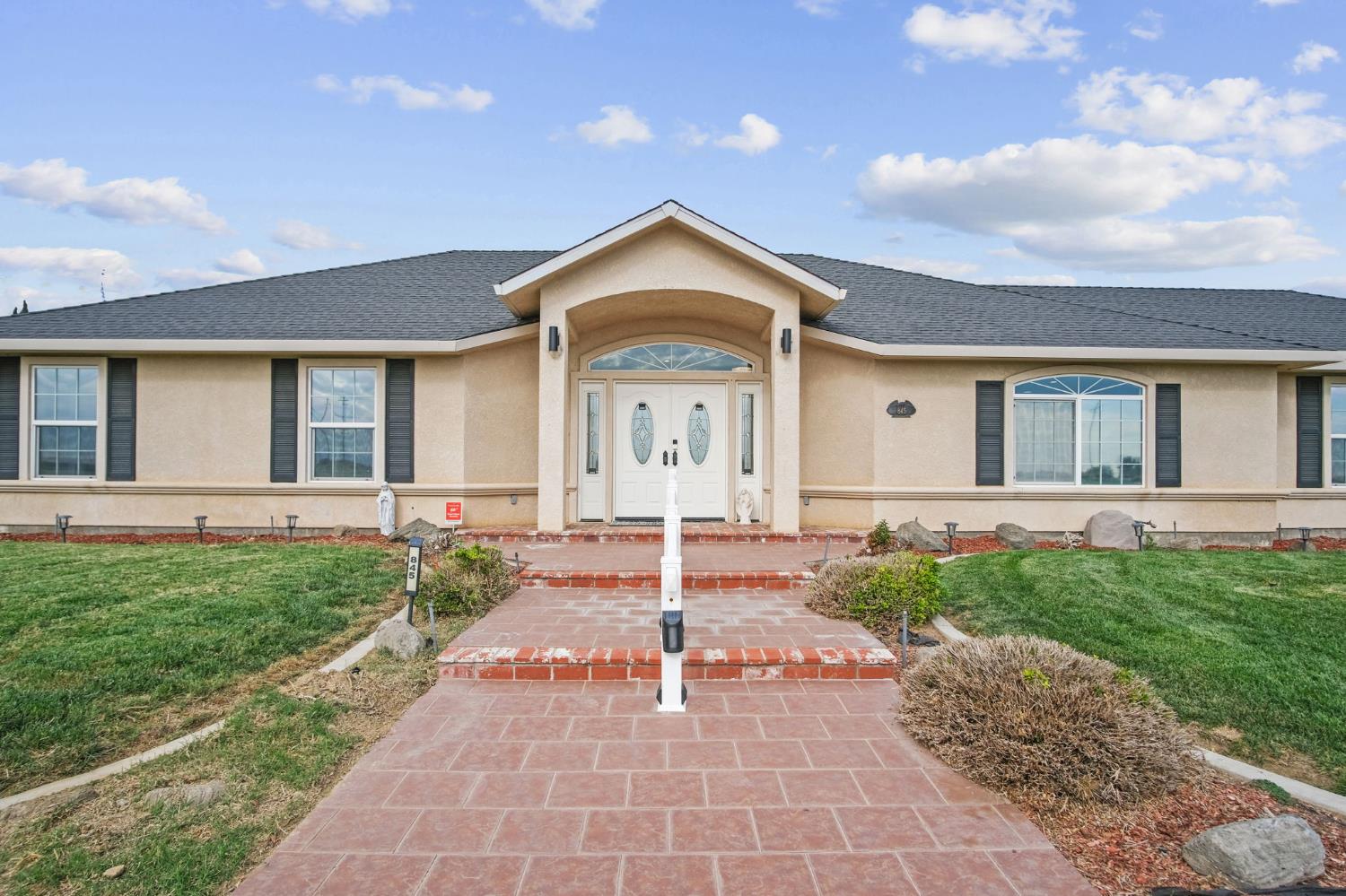 845 Pointe Lourose Avenue Gustine, CA 95322 - Photo 6 of 34 a view of a house with a small yard plants and large tree