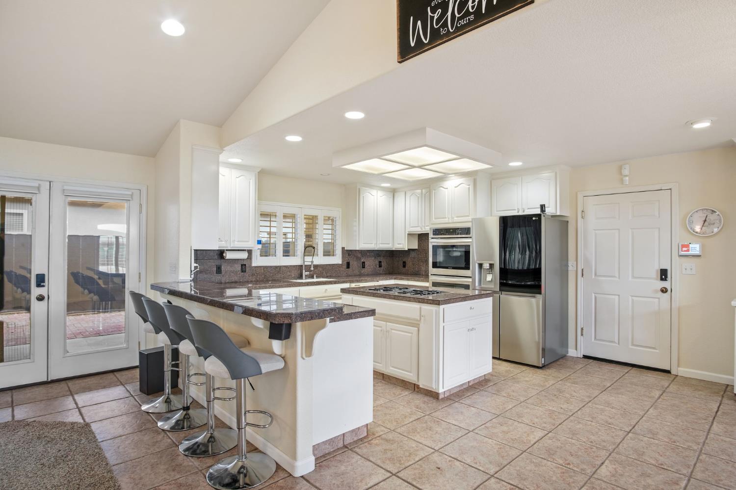 845 Pointe Lourose Avenue Gustine, CA 95322 - Photo 10 of 34 a kitchen with stainless steel appliances kitchen island granite countertop a sink and cabinets