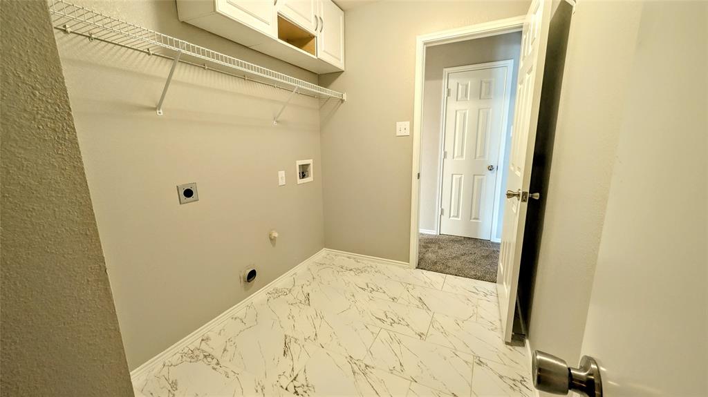 1308 Lamar Lane Allen, TX 75002 - Photo 12 of 40 Washroom featuring hookup for an electric dryer, marble look tiles, and washer hookup