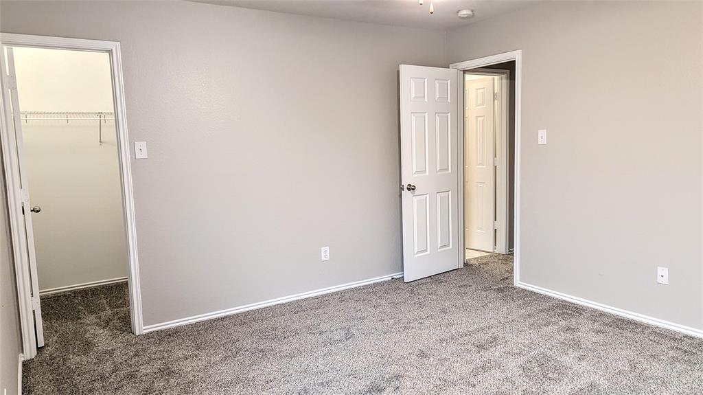 1308 Lamar Lane Allen, TX 75002 - Photo 14 of 40 Unfurnished bedroom featuring a spacious closet and carpet flooring